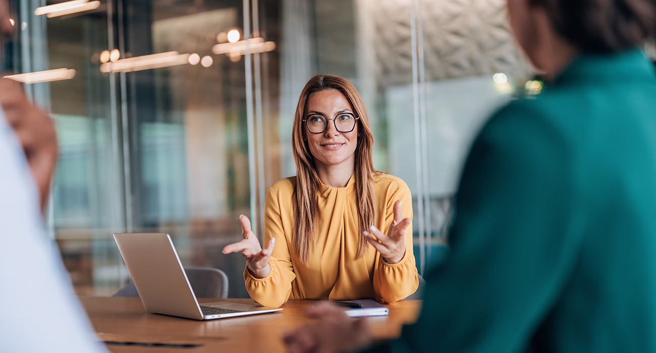 confident businesswoman talking to couple
