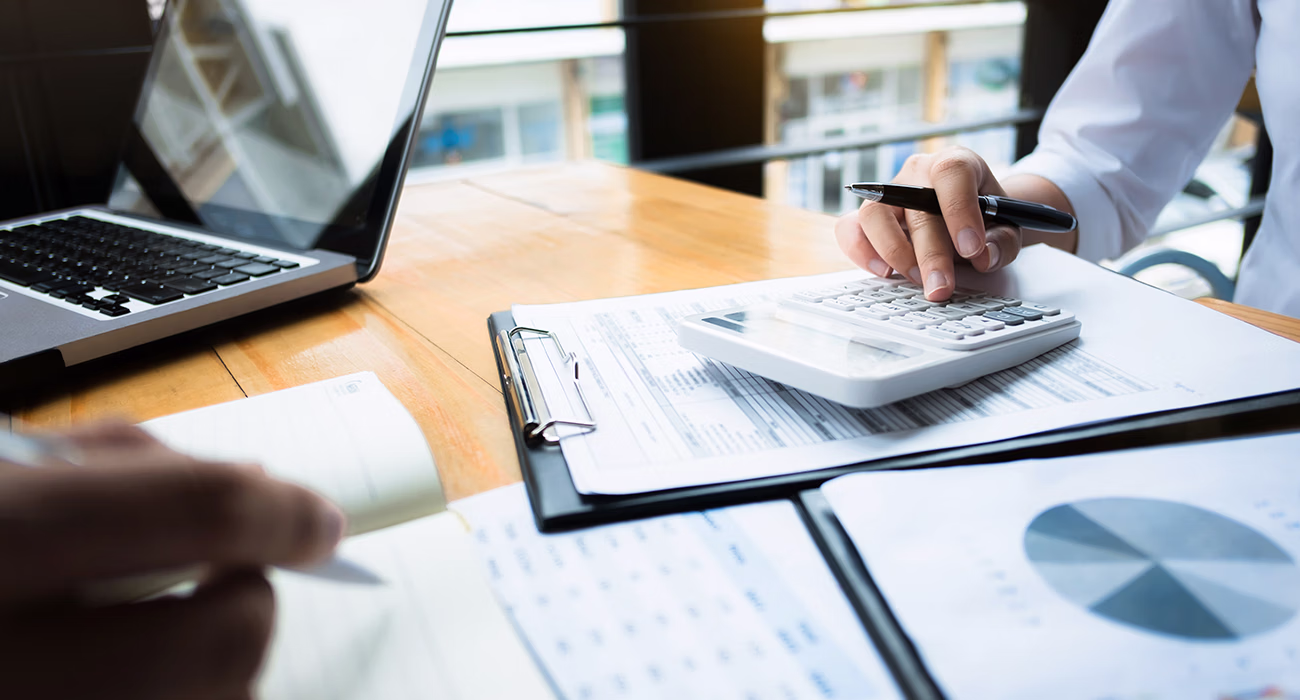 using a calculator financial data investment fund at a workplace
