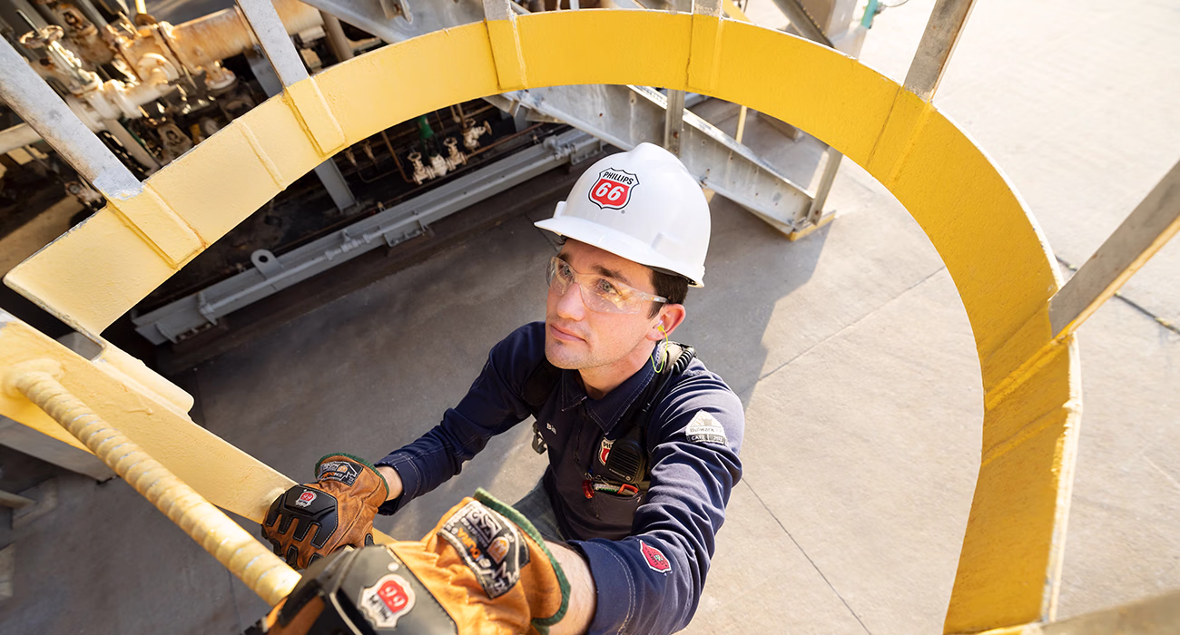Phillips 66 employee climbing a ladder