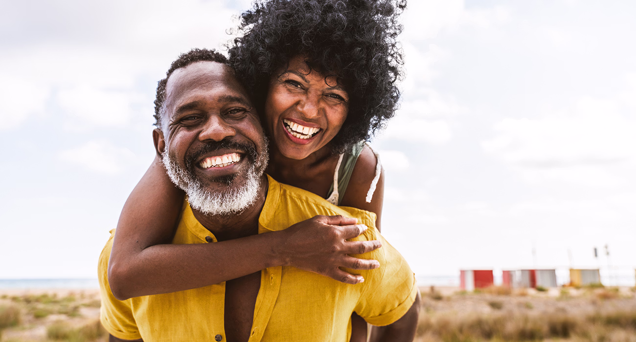 Beautiful mature black couple of lovers dating at the seaside