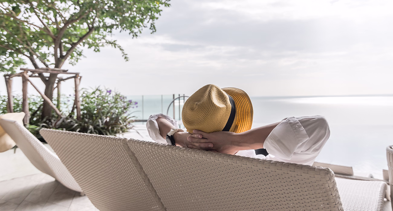 Relaxation holiday vacation of businessman take it easy happily resting on beach chair at swimming pool poolside beachfront resort hotel with sea or ocean view and summer sunny sky outdoor - A grandfather is teaching his grandson to fish during sunset in summer