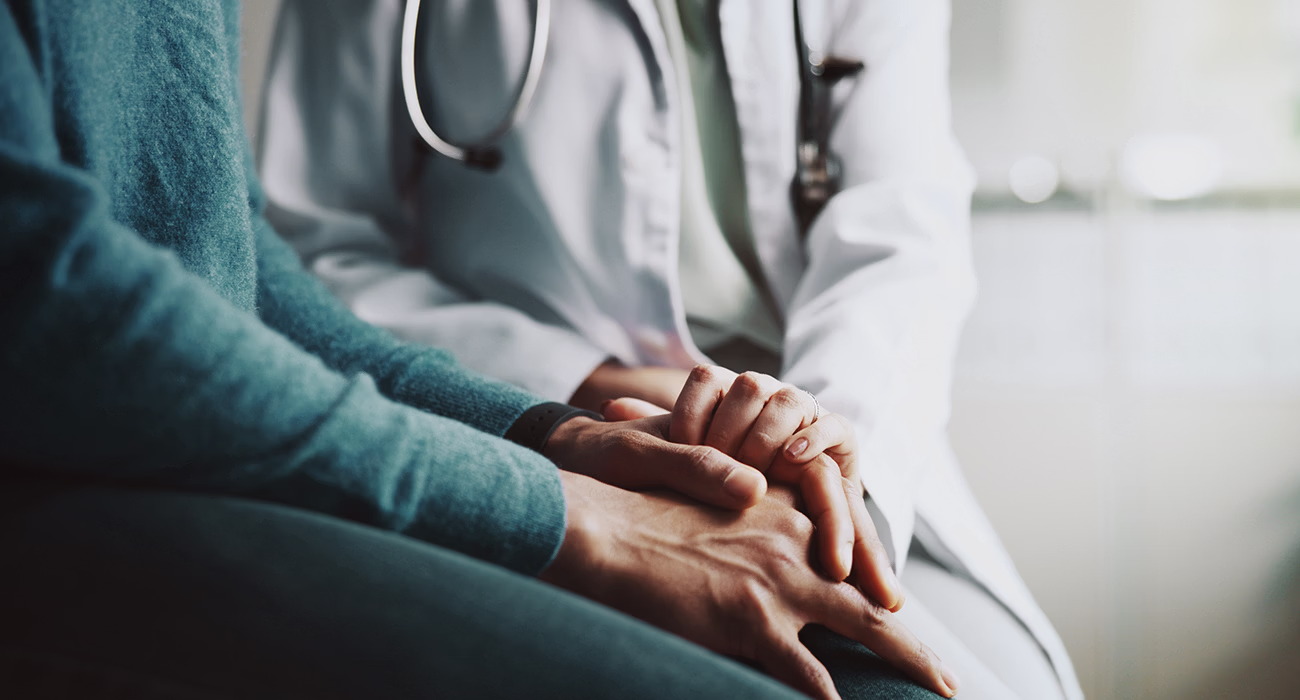 Holding hands, doctor and patient with comfort